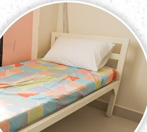 Made-up single bed in a Block A room